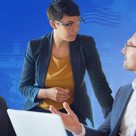 three executives talking in a meeting