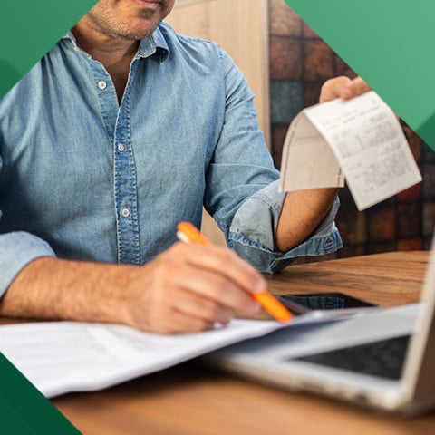 Small business owner calculating expenses