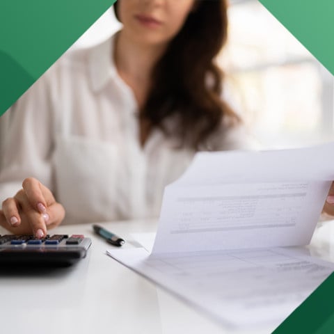 Business woman updating her ledger 