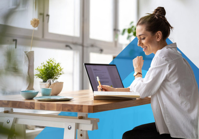 Woman business owner checking over policies on her laptop