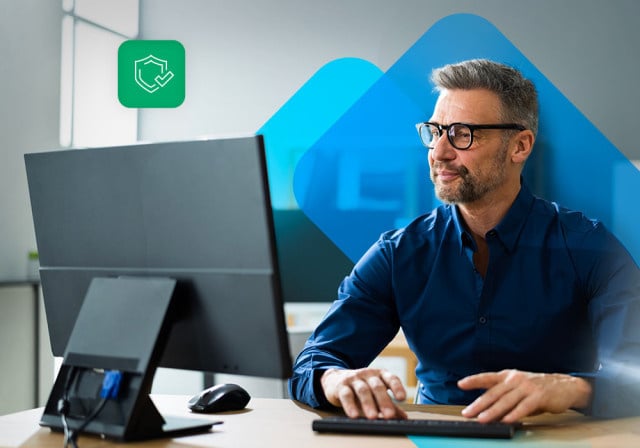 A business owner using a computer knowing his business is protected with cyber insurance