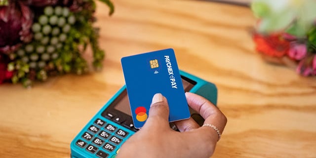 person paying with paychex pay card