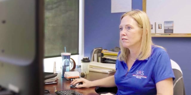 SAS Accounting employee works on the computer