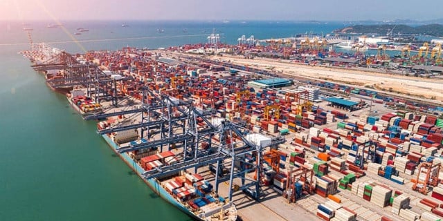 A busy port with shipping containers and cranes, representing international trade influenced by tariff