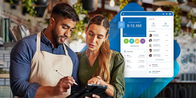Small business owners looking at payroll