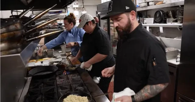 Employees at Lago 210 handle food prep work in the kitchen.