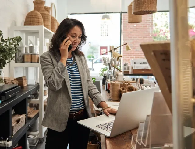 A small business owner working and on the phone