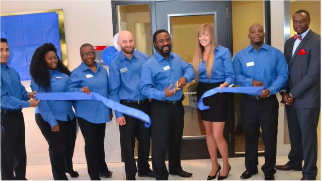 employees cutting ribbon