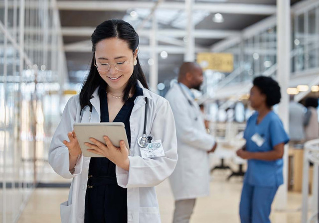 a healthcare worker using paychex for hr and payroll