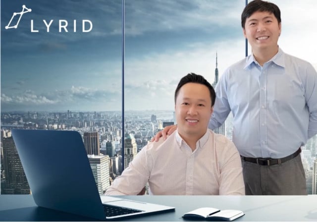 2 men pose against cityscape background