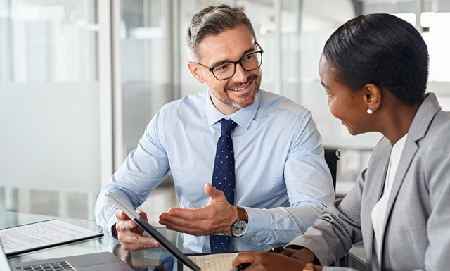 two coworkers discussing safe harbor 401(k) provision 
