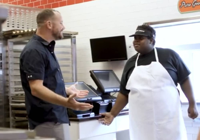 store owner chats with employee manning checkout