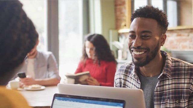 Hiring Manager smiles over computer
