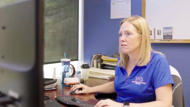 SAS Accounting employee works on the computer