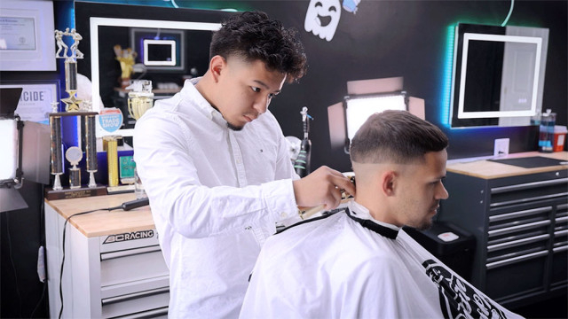 Rolando Duarte works in his new barbershop