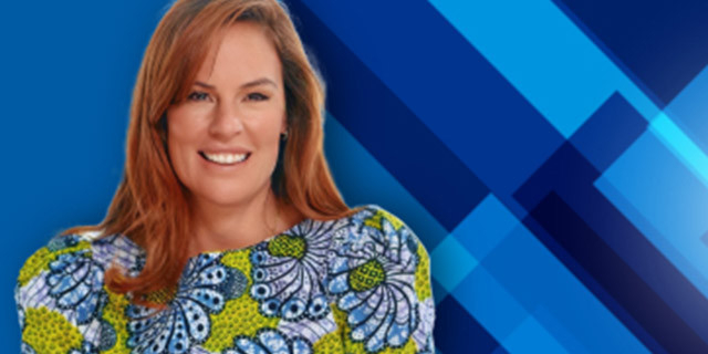 A person is shown from the shoulders up against a layered blue geometric background, wearing a patterned top and facing the camera.