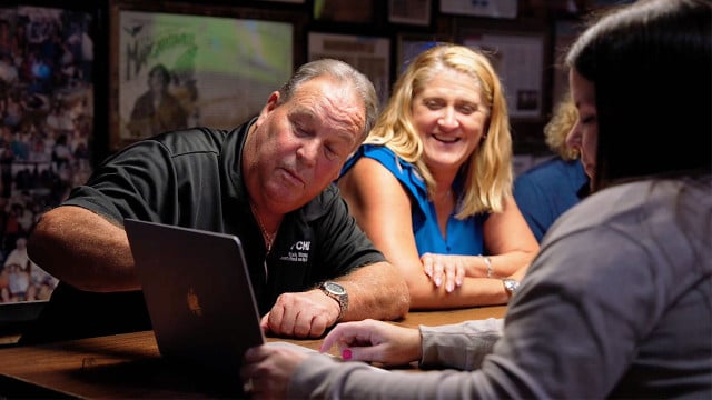 Members of the Paychex PEO team discuss reports with the HR staff from Flora-Bama.
