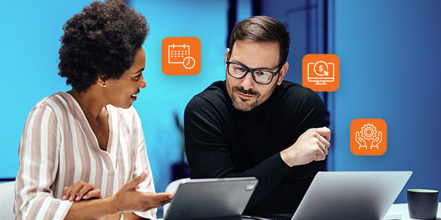Two colleagues review information on a tablet and laptop during a collaborative work session, with floating icons representing scheduling, financial reporting, and business insights.