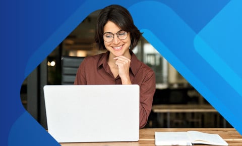 Happy employee working on laptop