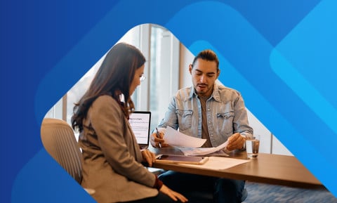 Recruiter and new employee signing paperwork