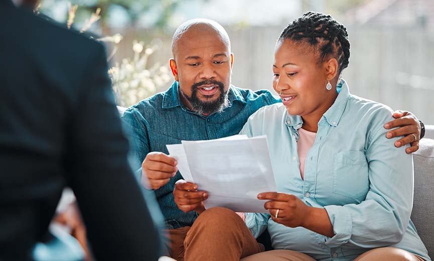 A couple looks into review a 401(k) summary plan document