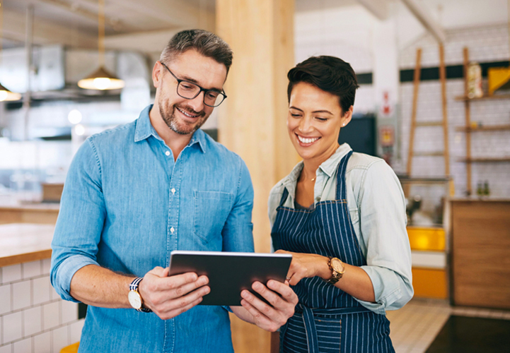 Two people looking at tablet